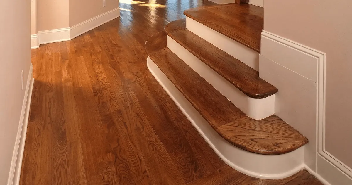 Base floor of a staircase with professionally restored wood flooring in Overland Park KS